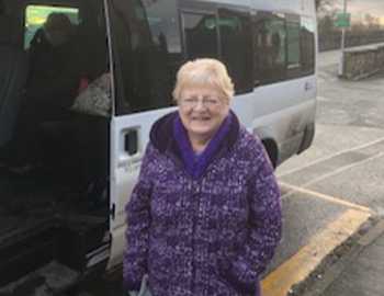 Lady stands by the bus